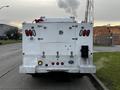 A white 2019 Ford F-350 SD with utility-style storage compartments and multiple rear lights