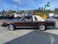 A brown 1982 Mercury Grand Marquis with a tan vinyl top parked side view showcasing its classic coupe style and chrome details