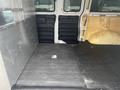 Interior view of a 2012 Chevrolet Express van showing empty cargo space with black rubber flooring and insulated walls