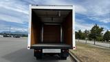 A 2018 Mitsubishi Fuso FE box truck with an empty cargo area and wooden interior panels