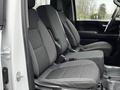 Interior view of a 2021 Chevrolet Silverado 3500HD with two front bucket seats in gray fabric and a center console between them