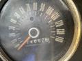 The speedometer of a 1966 Ford Mustang with a needle pointing just over 40 mph and a mileage counter displaying 74052 miles