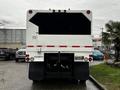 A white 2007 Freightliner M2 106 truck viewed from the rear with a boxy cargo area and red reflective stripes across the back