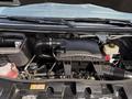 Engine compartment of a 2019 Mercedes-Benz Sprinter showing the air intake tube battery reservoir and various engine components