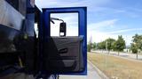 A blue door of a 2012 International DuraStar 4300 truck is open revealing the interior panel and mirror