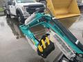A 2024 AGT Industrial MH12R Mini Excavator with a turquoise arm and yellow attachments in the foreground