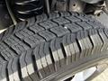 Close-up of a tire tread on a 2013 Ford Econoline showing detailed patterns and grooves