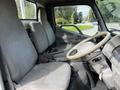 Interior of a 2004 Toyota Toyoace showing two cloth seats and a steering wheel focused on the driver's side