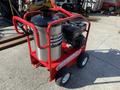 A red Magnum 4000 Hot Water Pressure Washer with a silver cylindrical tank and a black engine mounted on a wheeled cart