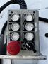 A control panel with various buttons and switches featuring labels for functions such as lift and lower with distinct areas for left and right movements