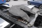 A large fifth wheel hitch on the chassis of a 2015 Kenworth T660 truck showing signs of wear and damage
