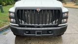 Front view of a 2021 International CV515 truck with a prominent black grille and a diamond-shaped emblem in the center