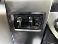 Close-up of the control panel in a 2018 Ford F-550 featuring two black switches with plus and minus symbols for adjustments