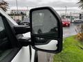 A 2020 Ford F-350 SD side mirror reflecting rain droplets