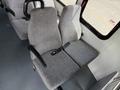 Two gray fabric seats with seat belts in a 2010 Ford Econoline interior