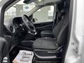 A 2019 Mercedes-Benz Metris interior featuring two front seats in black fabric and a dashboard with controls and an infotainment system