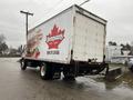 A 2006 GMC F7B042 truck with a large white cargo box featuring a red and white logo for Dempster's and the text "Made by Canada" on the rear side