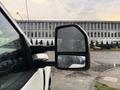 A 2017 Ford F-350 Super Duty with a close-up view of its side mirror showing raindrops on the glass