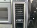 A close-up of a 2015 RAM 1500 air vent control panel featuring adjustable air vents and a small button for ventilation settings