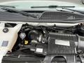 Close-up view of the engine compartment of a 2012 Chevrolet Express showing various components including the air intake hose and engine cover