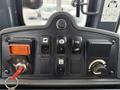 The control panel of a 2011 John Deere 310SJ 4x4 Wheel Loader featuring various buttons and switches for operating the machine