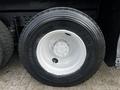 A close-up of a Michelin tire mounted on a white rim designed for a 2008 International 7500 truck with visible tread and a valve stem