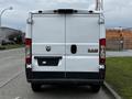 White 2018 RAM Promaster van viewed from the rear with the RAM logo and branding visible on the back doors