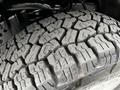 Close-up of a tread pattern on a tire of a 2016 Ford F-150 showcasing rugged, deep grooves designed for off-road traction and stability