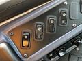 Control panel with four toggle switches labeled sun fan high med low and light settings in a vehicle