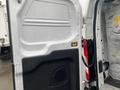 A 2018 Ford Transit with an open sliding side door displaying a yellow strap and an interior light indicator