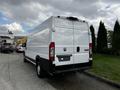 A white 2019 RAM Promaster van viewed from the rear with a high roof and large cargo space