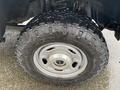 A close-up of a rugged tire on a 2017 Ford F-250 SD showcasing deep treads and a silver wheel