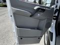 The image shows the side door of a 2017 Mercedes-Benz Sprinter featuring a gray interior design with a handle and a storage compartment