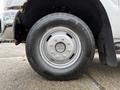 A close-up view of a silver wheel and tire of a 2013 Ford F-350 SD showcasing the tire tread and rim design