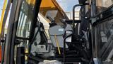 A 2018 Caterpillar 326F L Excavator showcasing its operator's cabin controls and seat