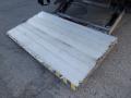 A lowered metal loading ramp with a white surface and yellow-striped edges attached to a 2014 International Durastar truck
