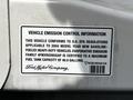 Vehicle emission control information label on a 2004 Ford Econoline detailing fuel tank capacity and compliance with U.S. EPA regulations