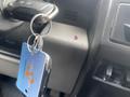 A close-up view of a 2017 Ford F-550 ignition key with a blue keychain attached