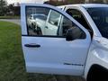 A 2017 GMC Sierra 1500 with an open driver door showing the interior and a reflection of another truck in the side mirror