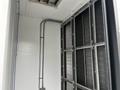 A Huntair Custom Air Handler Unit with metal frames and cooling coils arranged vertically within an enclosed structure