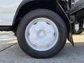 Close-up of the wheel of a 2007 GMC W5500 18 Foot Cube Van showing the white rim and black tire details