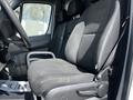 A black fabric driver's seat of a 2017 Mercedes-Benz Sprinter with adjustable armrest and seatbelt visible