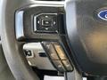 Steering wheel controls of a 2018 Ford F-550 featuring buttons for setting cruise control and adjusting various settings