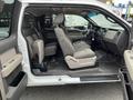 Interior of a 2010 Ford F-150 showcasing the front and rear seats in gray fabric with a spacious cabin design