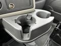 A black plastic cup holder with two cup compartments and a small circular indentation in the center, designed for use in the cabin of a 2013 International DuraStar