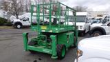 A green 2015 Skyjack SJ6826RT elevating scissor lift with a flat platform and guardrails positioned for height adjustment