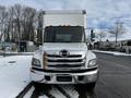 Front view of a white 2019 Hino 338 24-foot cube truck with a large cargo box and chrome grille