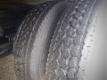 Two close-up tires of a 2013 Hino 308 showing tread patterns with visible wear and texture