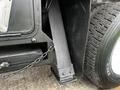 Close-up of a 2008 International 7500 truck's rear axle assembly featuring a black support brace and a tire with tread pattern visible