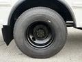 A close-up of a black wheel and tire from a 2013 International 4200 showing detailed tread and lug nut design